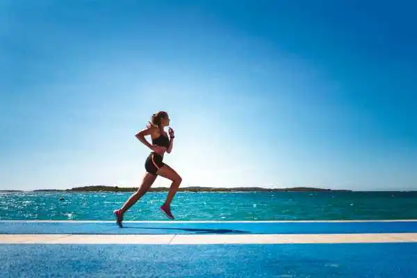 Woman running showing strong leg muscle Edgware
